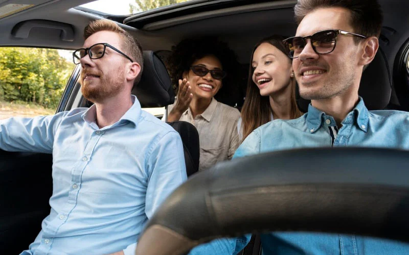 coach driver smiling/laughing, with a happy smiling group of passengers, February 2025, UK